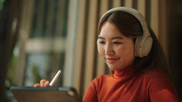 istock Asian woman drawing on her tablet. 2094236791