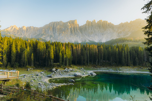 Idyllic view of scenic sunset at Later Mountain range with view of beautiful peaks, pine forest and crystal blue lake