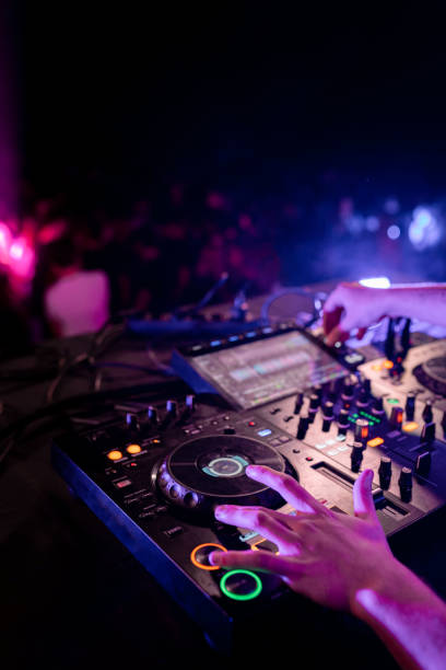 istock Hands of DJ performing in stage in a disco 2094334933
