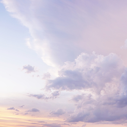 Blue purple lilac orchid pink peach white orange gold yellow cloudy evening sky background. Sunset clouds sun dawn summer. Delicate light pale pastel soft shades. Calm twilight sleep dream fantasy.