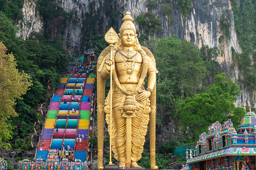 Kuala lumpur, Malaysia - 12 March, 2024. Batu Caves, a limestone cave that is more than 400 million years old, is a sacred place amidst mountains with colorful stairs and statues of Hindu gods.