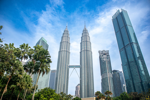 Petronas Twin Towers, an important symbol of Kuala Lampur, Malaysia, with beautiful landscapes around the building during the morning.