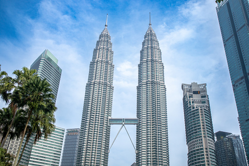 Petronas Twin Towers, an important symbol of Kuala Lampur, Malaysia, with beautiful landscapes around the building during the morning.