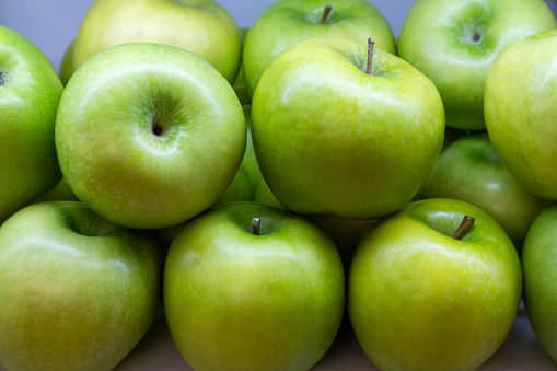 Fresh, beautiful, delicious green apples are ready for distribution after sorting for quality.