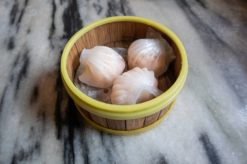 Deliciously fresh har gow in a beautiful wooden pot