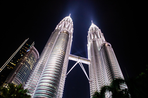 Petronas Twin Towers, an important symbol of Kuala Lampur, Malaysia, with beautiful landscapes around the building during the night.