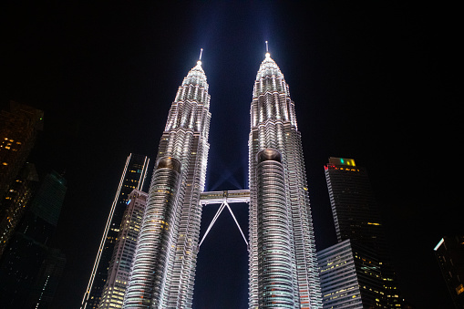 Petronas Twin Towers, an important symbol of Kuala Lampur, Malaysia, with beautiful landscapes around the building during the night.