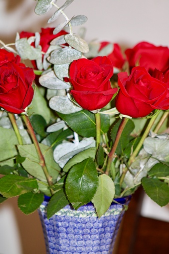 A bouquet of roses in a vase on a table.