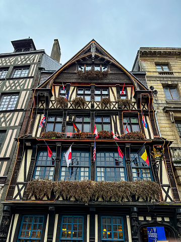 Rouen, France - 18.02.2024. Ancient market square or Place du Vieux Marche with historical half-timbered buildings. Storied square where Joan of Arc was executed in 1431, with a modern church dedicated to her. Rainy winter day, overcast