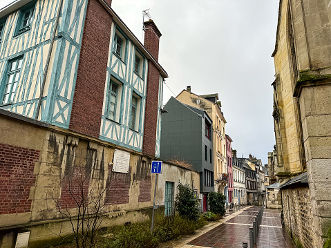 Rouen, France - 18.02.2024. Medieval street view of historical center of Rouen with half-timbered houses, Normandy, France. Downtown street view with fachwerk houses on a rainy winter day