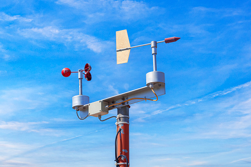 Meteorological antenna against the sky. Wind speed measuring device.