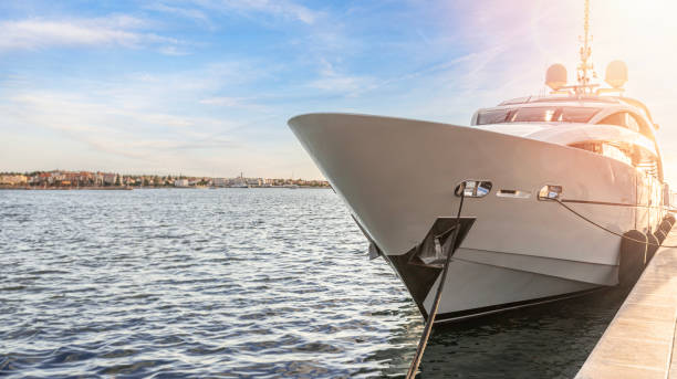 Pleasure ship on the sea waves. The yacht is moored to the shore in the port.
