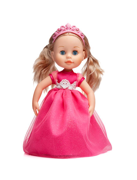 Doll in a pink dress isolated on a white background.