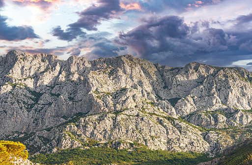 View of the rocky mountain and the contrasting cloudy sky. Croatia