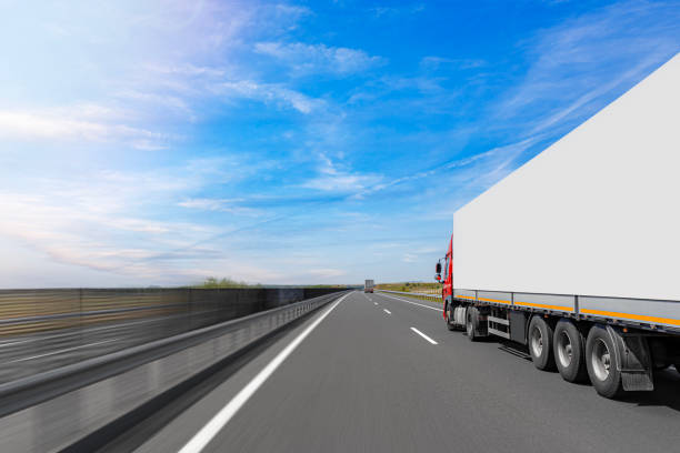White truck on the highway. White truck on asphalt road.