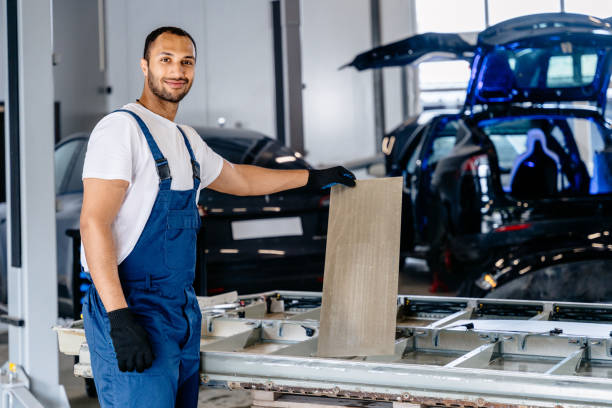 istock Handsome arabian mechanic man repairing electric car battery in workshop. Disassembling the battery of an electric vehicle engine. 2094458104