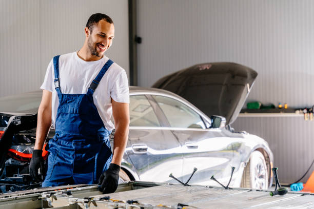 istock Arabian male technician engages with an EV Car Battery Cell Module in auto service. Maintenance engine repair. 2094458126