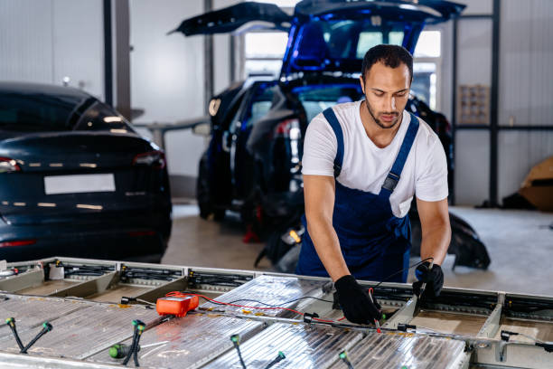 istock Arabian male technician engages with an EV Car Battery Cell Module troubleshooting a modern electric vehicle battery removed from the vehicle. Mechanic examining a car engine with voltmeter. 2094458394
