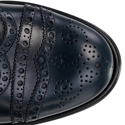 Close-Up of Brogue Detail on Navy Blue Leather Oxford Shoe. Textured