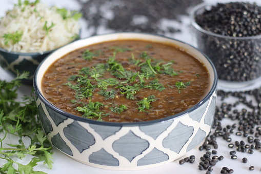 Flavorful maa ki dal paired with fragrant jeera rice, authentic Indian dish, vegetarian cuisine. Maa ki dal also known as kaali dal is a popular Indian dish made from black lentils, that is urad dal