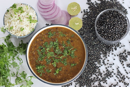 Flavorful maa ki dal paired with fragrant jeera rice, authentic Indian dish, vegetarian cuisine. Maa ki dal also known as kaali dal is a popular Indian dish made from black lentils, that is urad dal