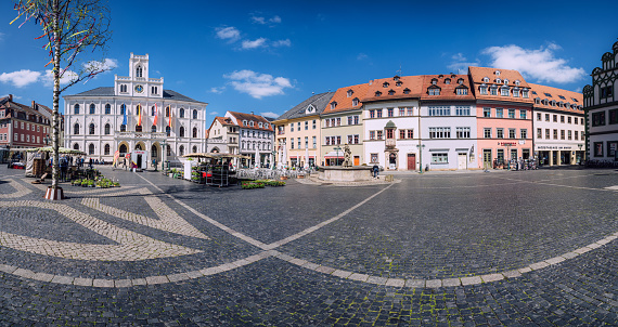 Panoramic view of the historic market square in Weimar, Germany, on a bright sunny day with clear blue sky.