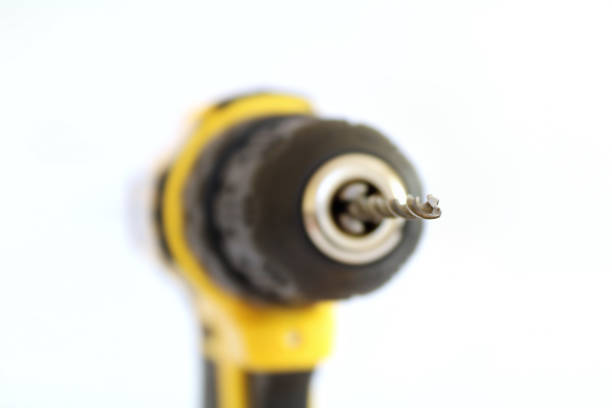 Close-up drill isolated. Yellow battery drill white background.