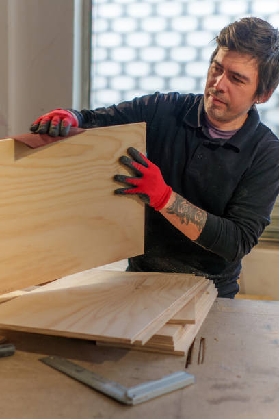 istock Hispanic male carpenter working standing in woodworking shop 2094510436