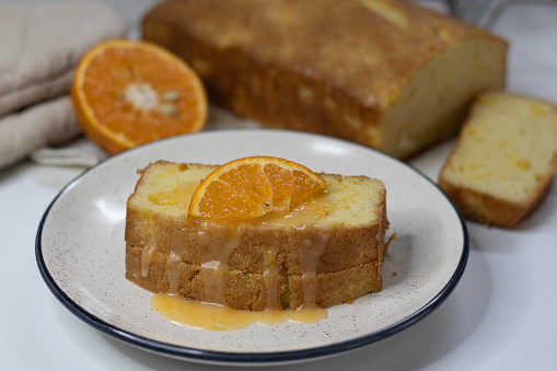 Slices of Orange pound cake, also known as citrus loaf cake or orange butter cake. Moist, flavorful dessert, with zesty glaze perfect for food lovers, baking enthusiasts, and for sweet cravings