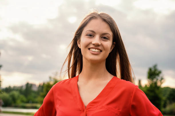 istock Smiling Young Woman in Red Outdoors 2094518933
