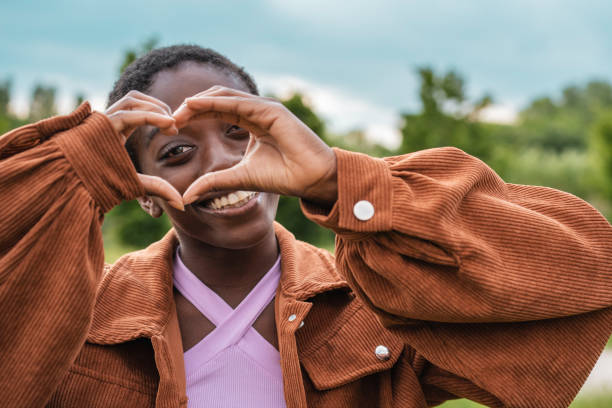 istock Joyful African Girl Forming Heart Shape with Hands 2094518935