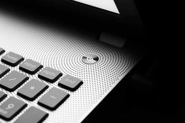 Black laptop with empty white screen isolated on white background, angled view. Ideal for mockup, advertising, e-learning, office, business, and technology concepts. Clipping path.