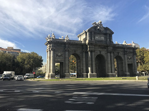 Madrid, Spain - November 15, 2017: The Puerta de Alcala Neo-classical gate in the Plaza de la Independencia. Newly restored iconic monument