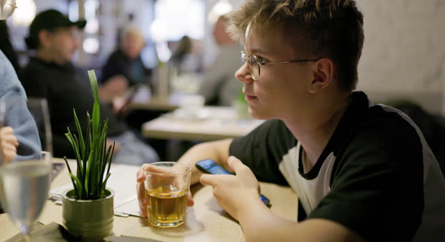 Teenagers enjoying lemonade while waiting for the order in restaurant