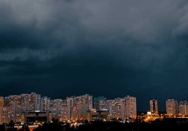 Dramatic stormy dark cloudy sky over row of typical residential district.