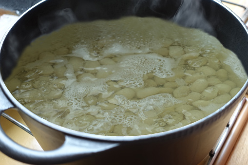 Beans in a casserole dish cooked in boiling water with food bicarbonate