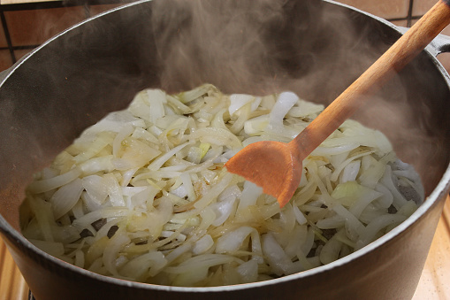 Sliced onions being cooked to make onion soup  French cuisine