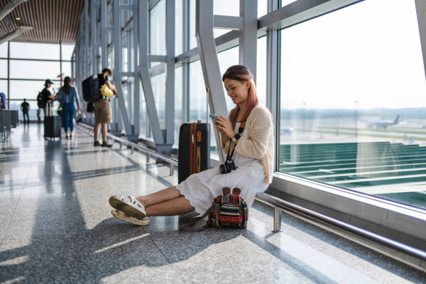 istock Travel Tech: Asian Woman's Smartphone Preparations at the Airport 2094569267