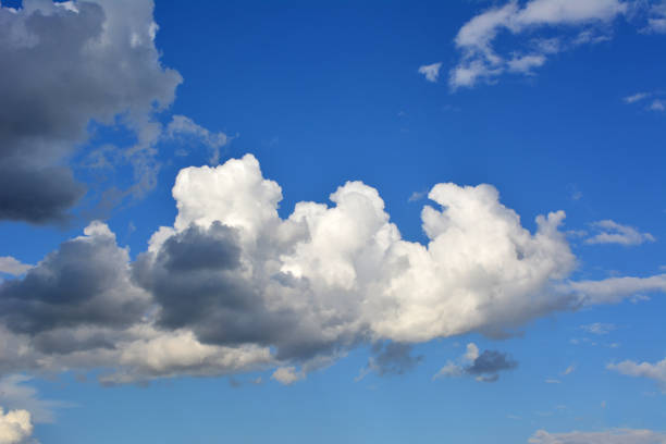 cumulus white and gray clouds in the blue sky