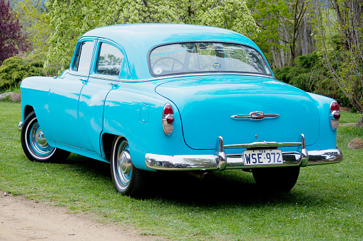 Brighton, Tasmania, Australia, October 6, 2012: View of a beautiful vintage blue Chevrolet motor vehicle in excellent condition, being used as a wedding car, parked on lawns outside a reception venue