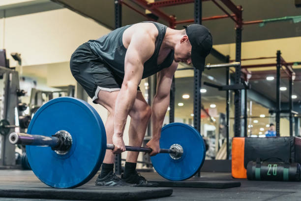 istock Focused athlete in cap, ready to perform deadlift in gym. 2094577395
