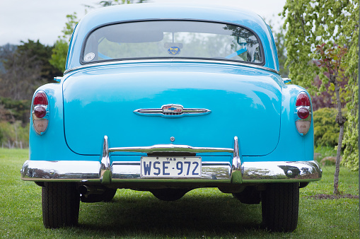 Brighton, Tasmania, Australia, October 6, 2012: View of a beautiful vintage blue Chevrolet motor vehicle in excellent condition, being used as a wedding car, parked on lawns outside a reception venue