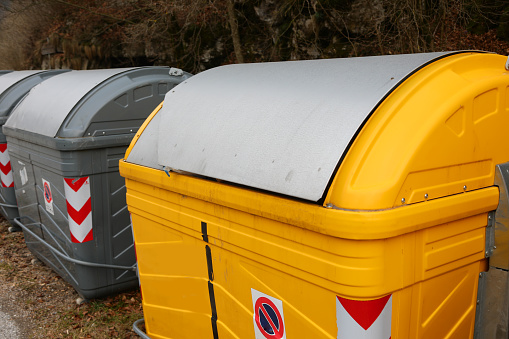 many yellow bins in the recycling center of the city ecological oasis for the separate collection of waste