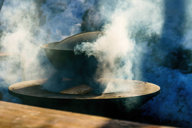 istock Cast iron pot on the hearth in smoke 2094595062