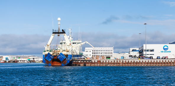 Reykjavik, Iceland - April 4, 2017: Fishing trawler is loading in port. An Icelandic stern trawler