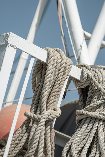 Thick rope secured on boat railing