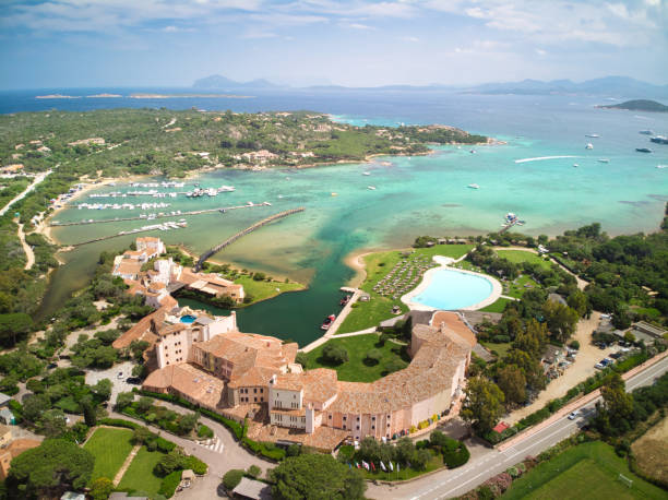 Aerial Portrait Showcasing the Famous Cala di Volpe Bay, Known for its Crystal-clear Waters and Pristine Coastline A Spectacular Aerial Portrait Showcasing the Famous Cala di Volpe Bay, Known for its Crystal-clear Waters and Pristine Coastline, Nestled Amidst the Stunning Scenery of the Sardinian Coastline Cala Di Volpe stock pictures, royalty-free photos & images