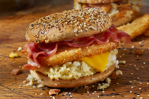 Everything  Bagel Breakfast Sandwich with Scrambled Eggs, Bacon, Cheddar Cheese and Crispy Hashbrowns
