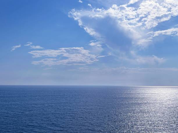istock Blue sea shiny calm water and sky clouds 2094638030