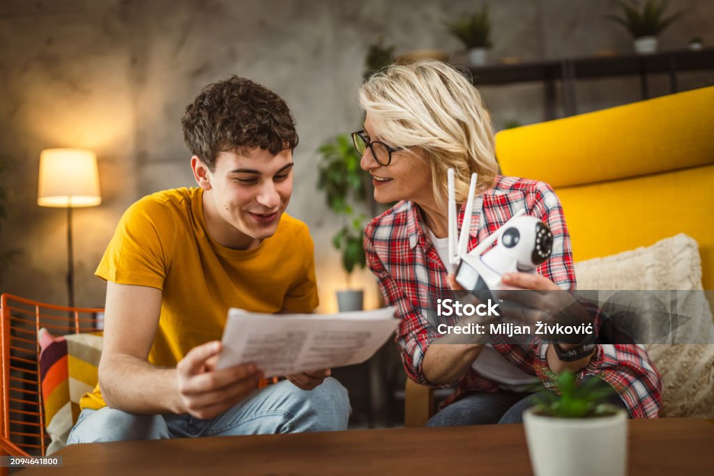 Mother And Son Adjust And Install Home Cctv Video Surveillance Camera